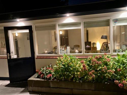 a building with a bunch of flowers in front of it at Have a nice stay! - Beachhouse Stranddistel 100m from the beach in Noordwijk aan Zee