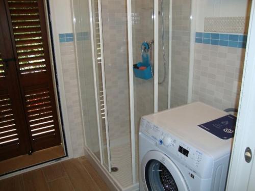 a washing machine in a bathroom with a shower at Bilocali e Mono al mare in Senigallia