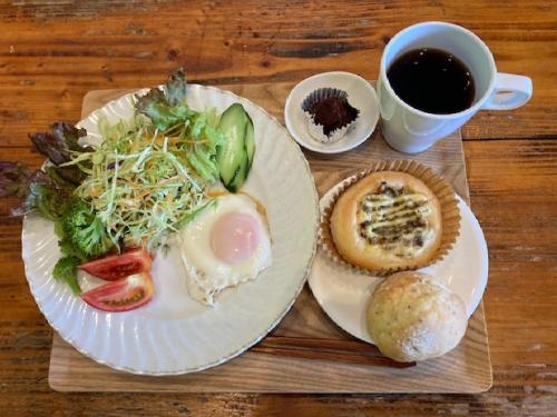 a table with two plates of food and a cup of coffee at Female Only Dormitory Guest House Amami Long Beach 2 Breakfast included- Vacation STAY 64534v in Amami