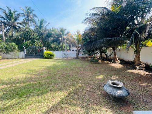 a vase sitting in the middle of a yard at Pasidu Villa in Kalutara