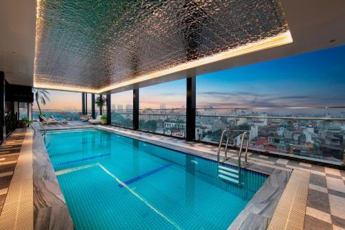 a swimming pool on the roof of a building with a view at May De Ville Luxury Hotel & Spa in Hanoi