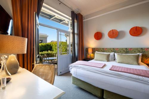 a bedroom with a bed and a table with a lamp at Welgelegen House in Cape Town