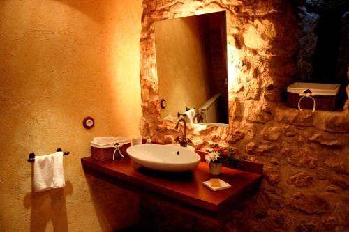 a bathroom with a sink and a large mirror at Masia Sapera in Pontons