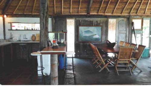 a kitchen with a table and chairs in a room at Vertical House Bali in Uluwatu