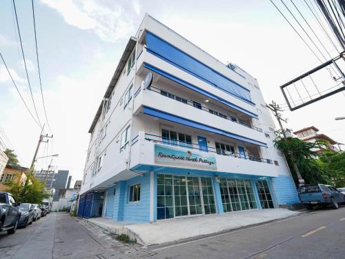 a blue and white building on the side of a street at RQ North Pattaya by Collection O in North Pattaya