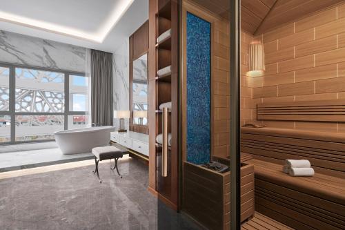 a bathroom with a tub and a bath tub at JW Marriott Hotel Istanbul Marmara Sea in Istanbul