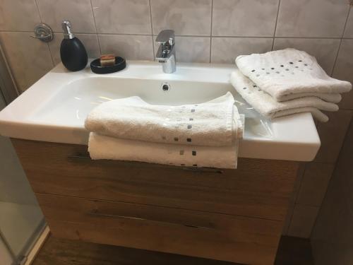 a bathroom sink with towels on top of it at Haus Christina in Sankt Johann im Pongau