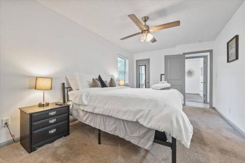 a bedroom with a large bed and a ceiling fan at NEW! Modern Comforts w/ 4Beds/3BR Sleeps 8 in Atlanta