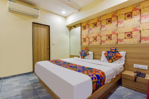 a bedroom with a large bed in a room at FabHotel Vishala in Ahmedabad