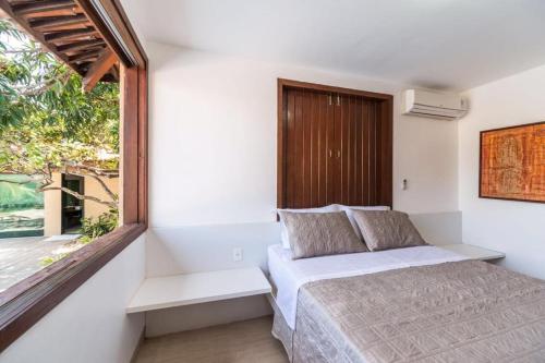 a bedroom with a bed and a window at Casa de praia completa in Paulista