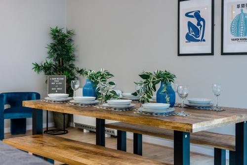 a dining room table with plates and glasses on it at Host & Stay - Ropewalks Quarters in Liverpool