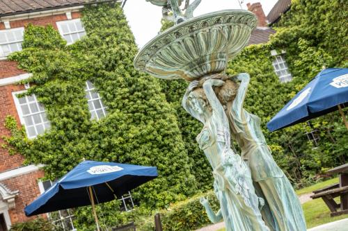 a statue of a woman with a bowl on her head at Park House Hotel in Shifnal