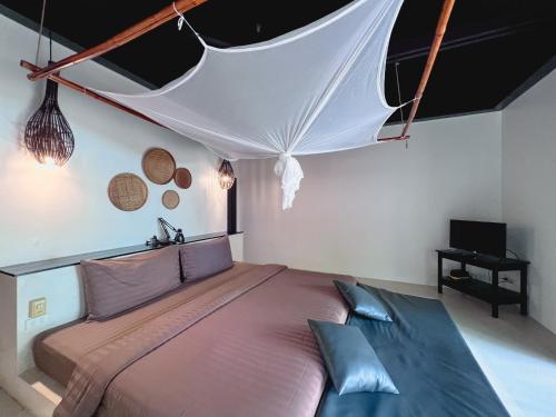 a bedroom with a large bed in a room at The Sevenseas Resort Koh Kradan in Koh Kradan