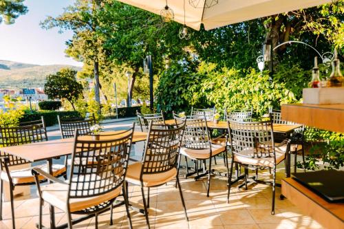 a group of tables and chairs on a patio at Heritage Hotel Pasike in Trogir