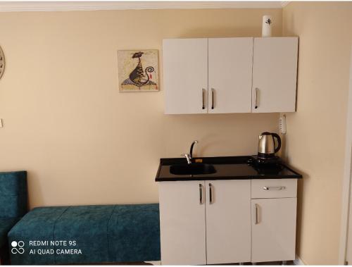 a kitchen with white cabinets and a sink in a room at Sultanahmet Center View Apart Hotel in Istanbul