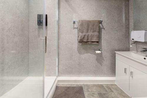 a bathroom with a shower with a glass door at Neat Retreat Graig Pontypridd in Pontypridd