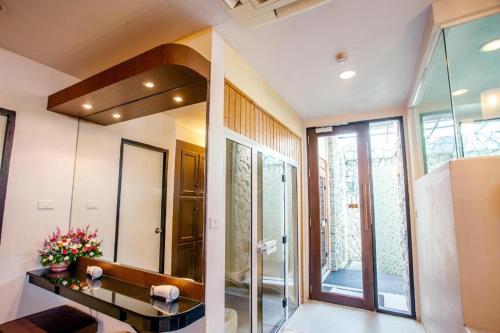 a bathroom with a sink and a mirror at Phi Phi Banyan Villa in Phi Phi Don