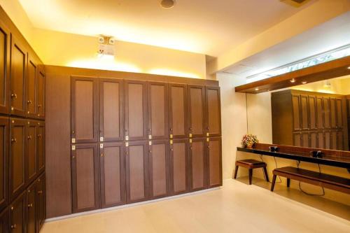 a locker room with wooden lockers and a bench at Phi Phi Banyan Villa in Phi Phi Don