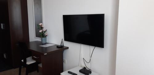 a hotel room with a television on a wall at Garni hotel Niksic in Nikšić