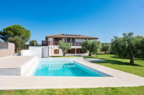 a villa with a swimming pool and a house at Ollu e Stentu in Dolianova