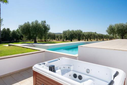a bath tub on the roof of a house with a swimming pool at Ollu e Stentu in Dolianova