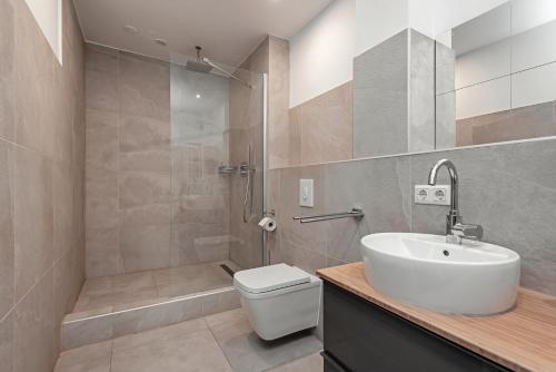 a bathroom with a toilet and a sink and a shower at Schönes Serviced Apartment in Berlin in Berlin