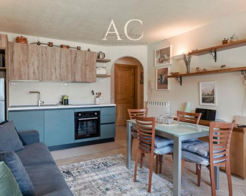 a kitchen and living room with a table and chairs at Villa Nice View in Ponte di Legno