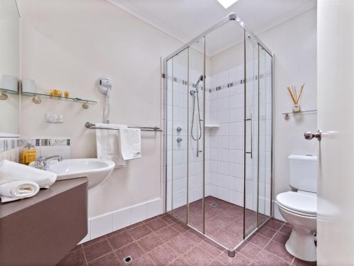 a bathroom with a shower and a toilet and a sink at The Noble Grape Guesthouse in Cowaramup