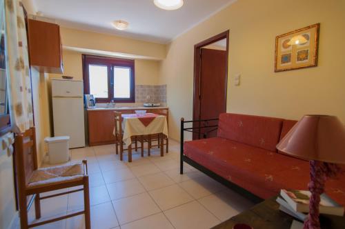 a living room with a couch and a table at Aeriko Benovias Rooms & Apartments in Karfas
