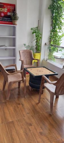 a table and chairs in a room with a table and chairs at Sthanvi Homestey in Ujjain