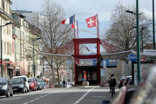 a person riding a bike down a street with canadian flags at Appartement 3 personnes, Frontière Suisse (Bâle) in Saint-Louis