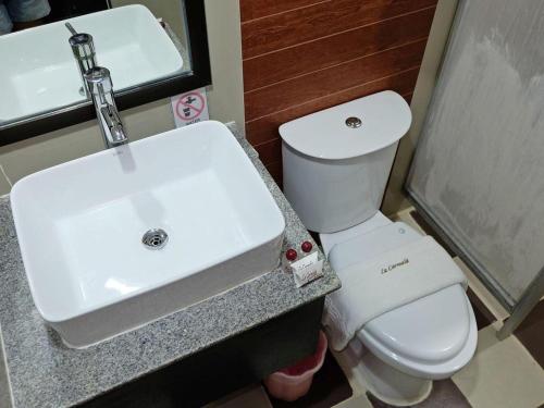 a bathroom with a white sink and a toilet at La Carmela de Boracay Hotel in Boracay