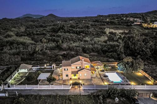 an aerial view of a house with a pool at Skidi Beach house in Ágios Matthaíos