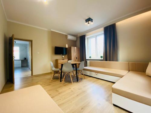 a living room with a couch and a table at Gold Apartament in Świdnik