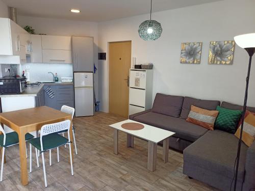 a living room with a couch and a table and a kitchen at Apartamento Rosamar, sea view in Los Cristianos