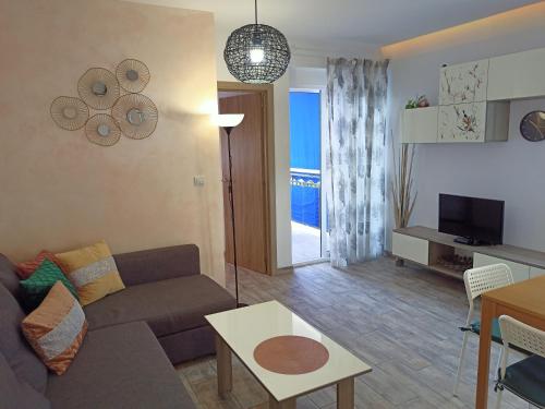 a living room with a couch and a table at Apartamento Rosamar, sea view in Los Cristianos