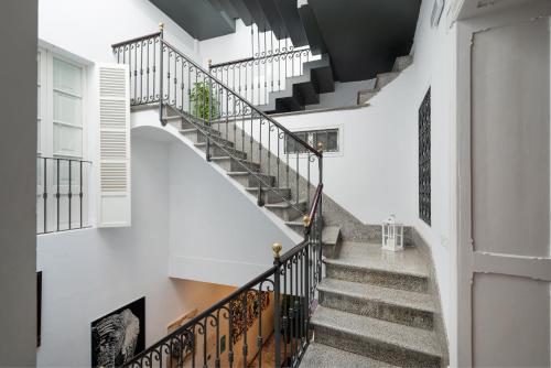 a winding staircase in a white building with white walls at Brondo Architect Hotel in Palma de Mallorca