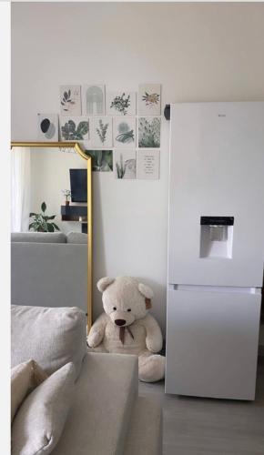 Un ours en peluche assis dans le coin d'une pièce dans l'établissement Appartement cosy et bien équipé, à Nanterre