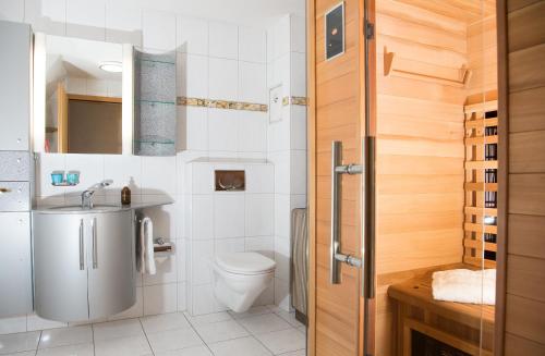 a bathroom with a toilet and a sink at Ferienhaus Tgantieni Ski-in Ski-out-Lenzerheide in Lenzerheide