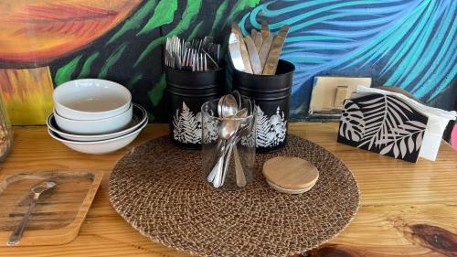 a table with plates and utensils on top at Bayahibe Lodge in Bayahibe