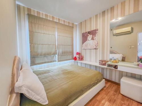 a bedroom with a large bed and a mirror at Trust Luxury in Hua Hin