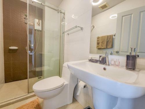 a bathroom with a sink and a toilet and a shower at Trust Luxury in Hua Hin