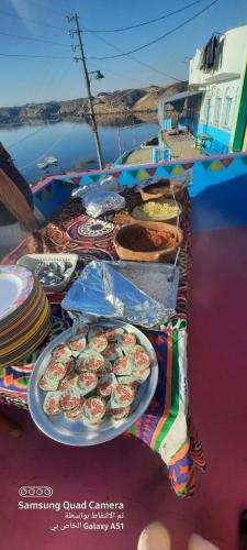 a table with plates of food on a boat at Asilah kato nubian guest house in Aswan