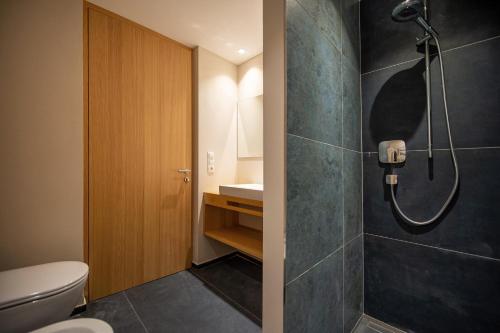 a bathroom with a shower and a toilet at Greva Apartments 1 in Santa Cristina in Val Gardena