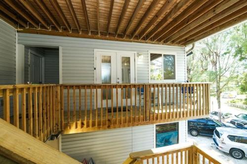 a house with a wooden deck with a car garage at Guld Drive House #54599 Home in Holmes Beach