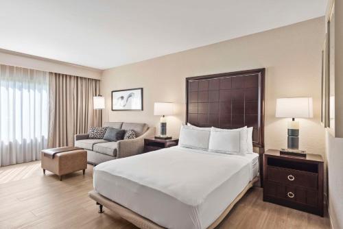 a hotel room with a large bed and a chair at DoubleTree by Hilton Columbus in Columbus