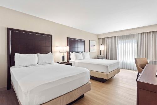 a hotel room with two beds and a desk at DoubleTree by Hilton Columbus in Columbus