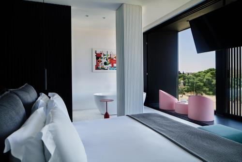 a bedroom with a bed and a large window at MAP Boutique Hotel in Nicosia