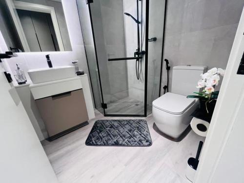 a bathroom with a shower and a toilet and a sink at Dar Alsalam - Premium and Spacious 1BR With Balcony in Noor 2 in Dubai