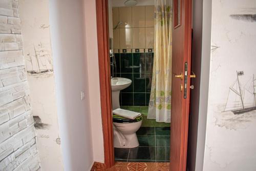 a bathroom with a toilet and a sink at Sunset by Old Town in Constanţa